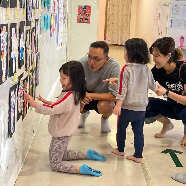 Students showcasing their art to parents at the Art Exhibition.