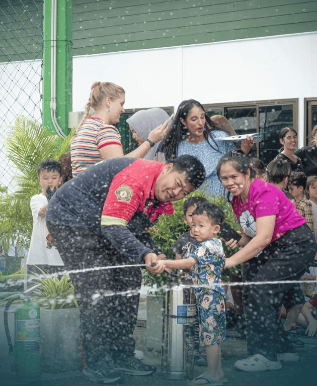 Young children enjoy playful water activities at school.