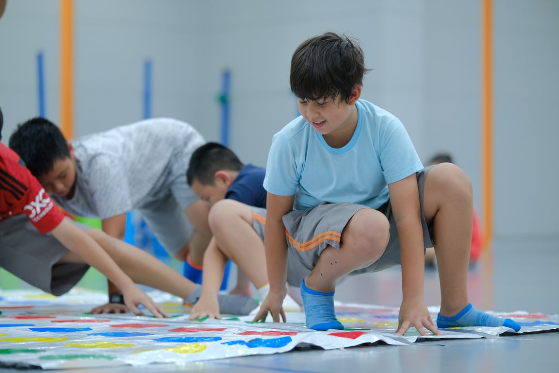 Students playing twister during sports day.