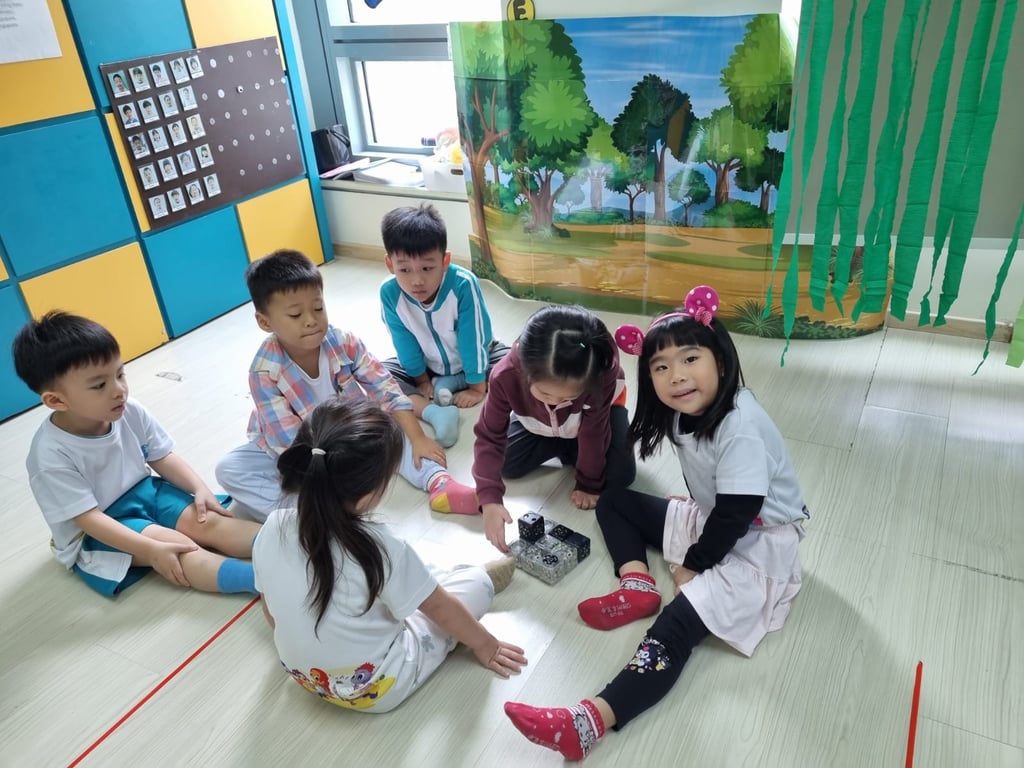 The children using cubelets to build a robot, an activity introducing them to technology.