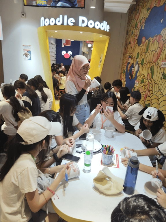 Students decorate their own noodle cups during a fun learning excursion.