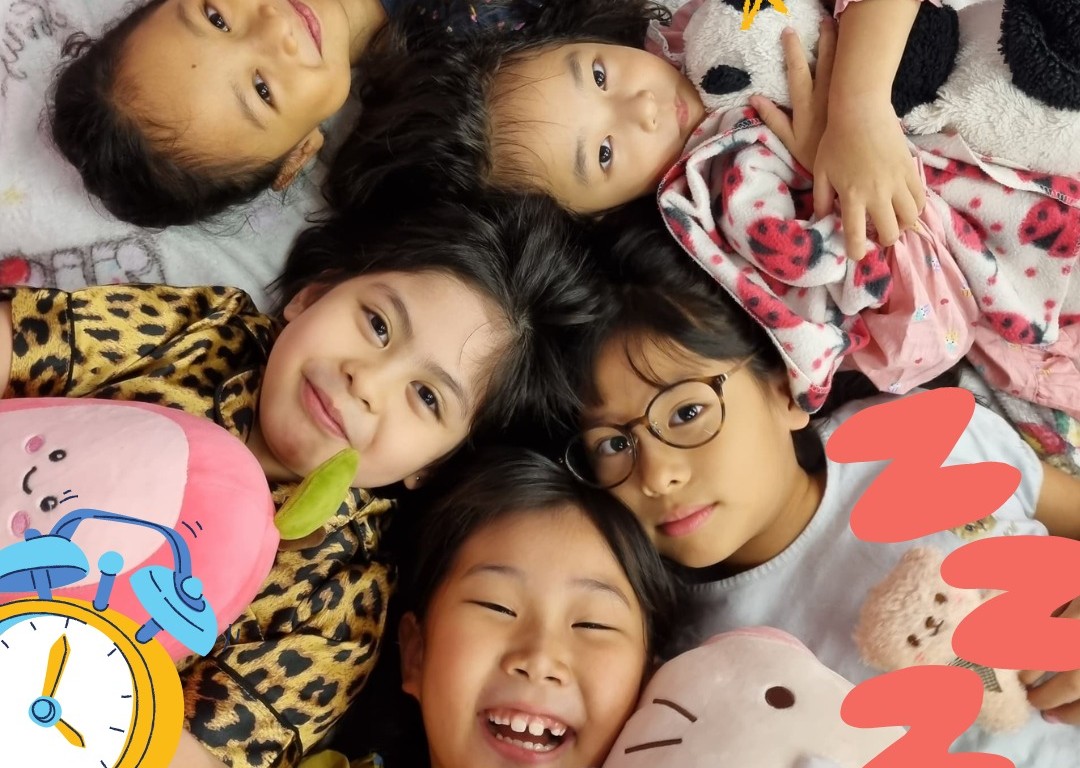 Primary students enjoy a cozy and cheerful Pyjama Day, celebrating friendship and comfort with plush toys and big smiles.
