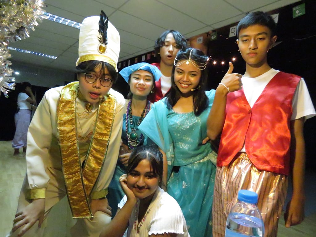 Cast members in costume after performing Aladdin at GIS.