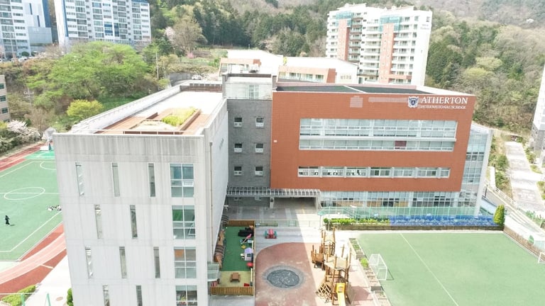 Atherton International School campus with playgrounds and sports courts.