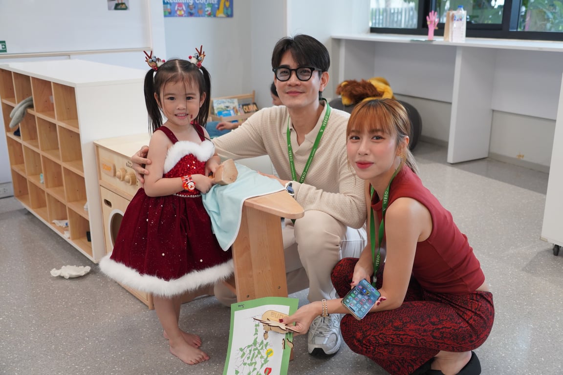 A family posing together at the Early Years Showcase event.