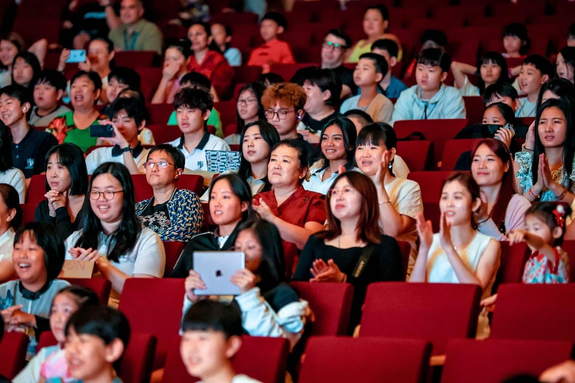 Families cheering for Lunar New Year performances. 