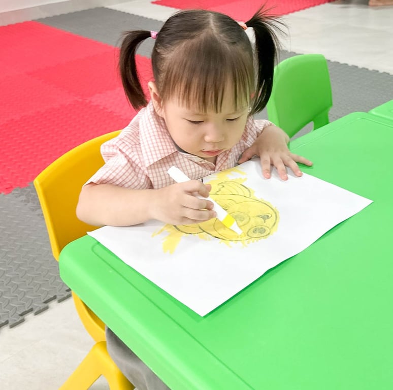 Young student colouring a picture during classroom activity.