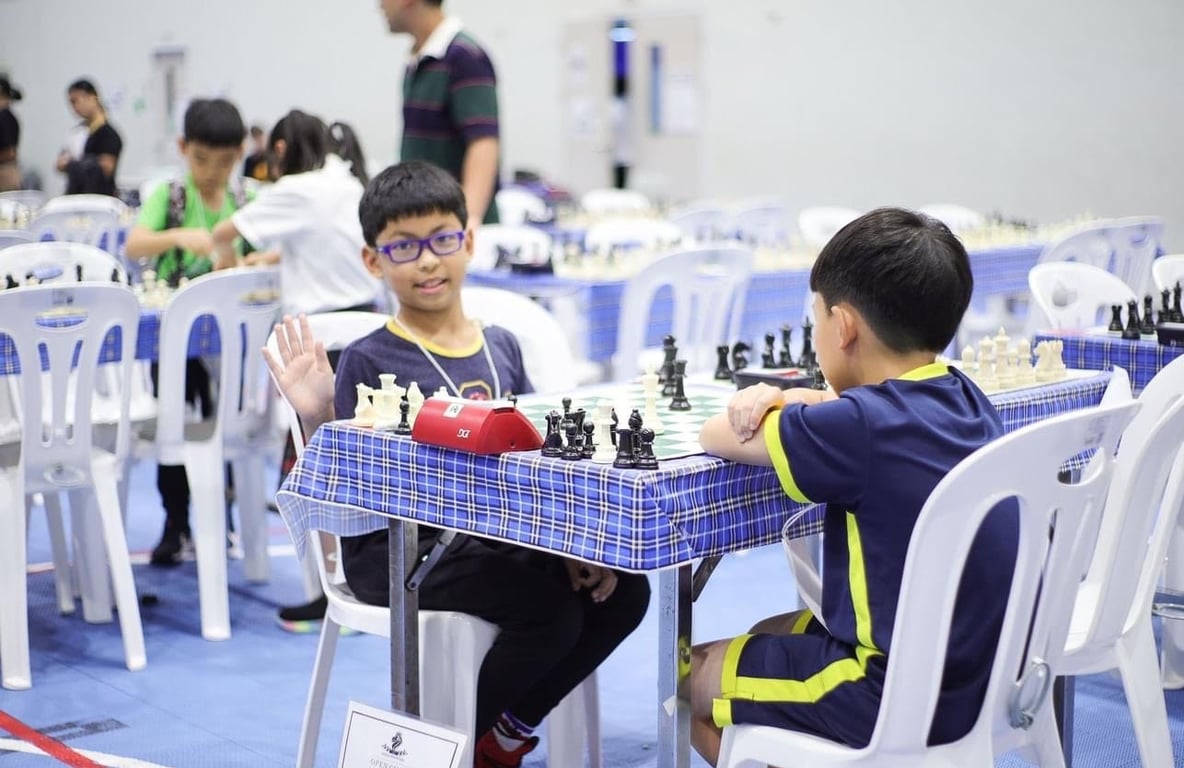 Primary students competing in a chess match during an on-campus event.