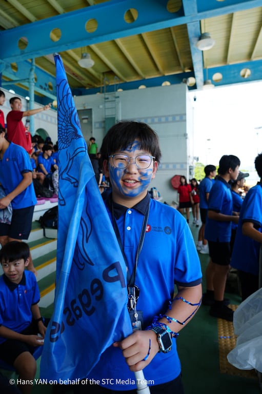 A student supporting his house during the annual swim gala.