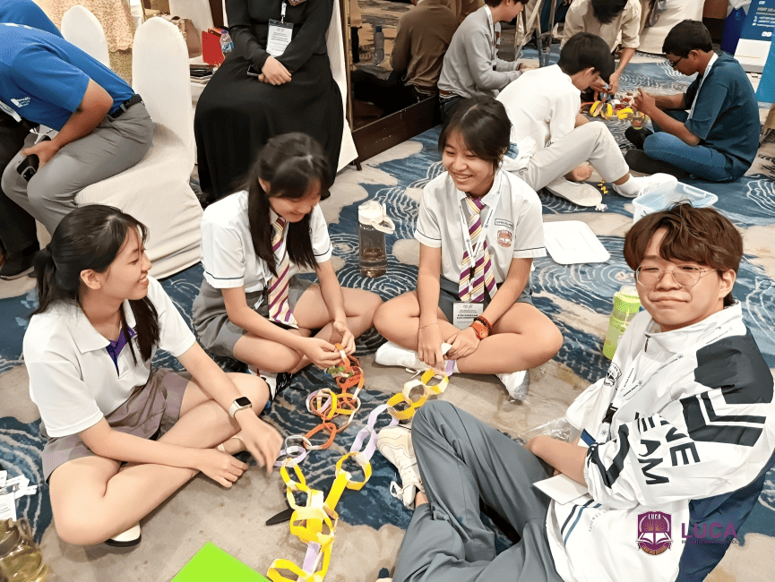 Students collaborate to build a paper chain as part of a leadership workshop.