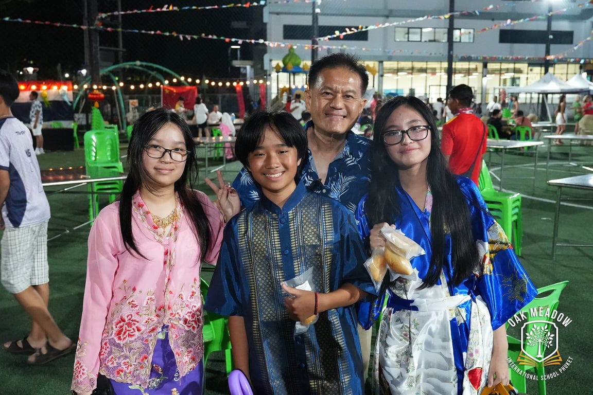 A family posing at the Oak Meadow International Day Event.