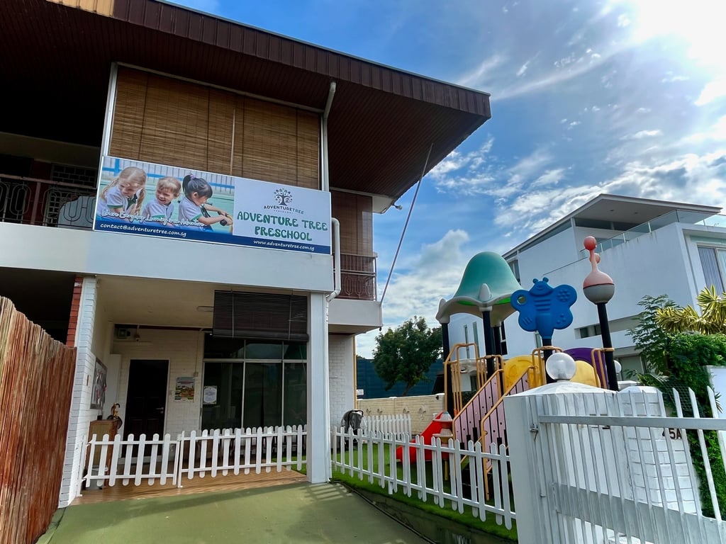 The front entrance to the Braddell campus, with a view of the outdoor recreational area