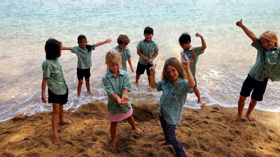 Group of students at the beach for a class activity.