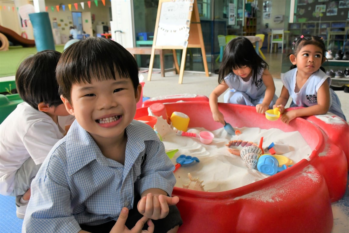 Young learners enjoy creative play in the sandbox, exploring textures and shapes.