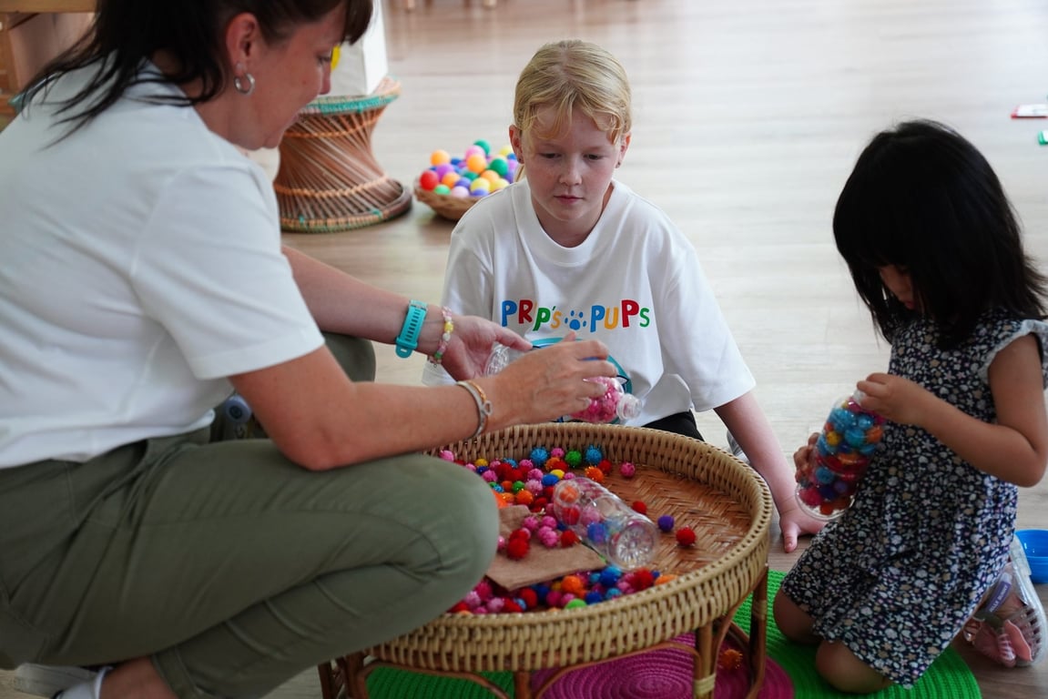 Children sorting colourful pom-poms during Prep Pups Jungle Fun session.