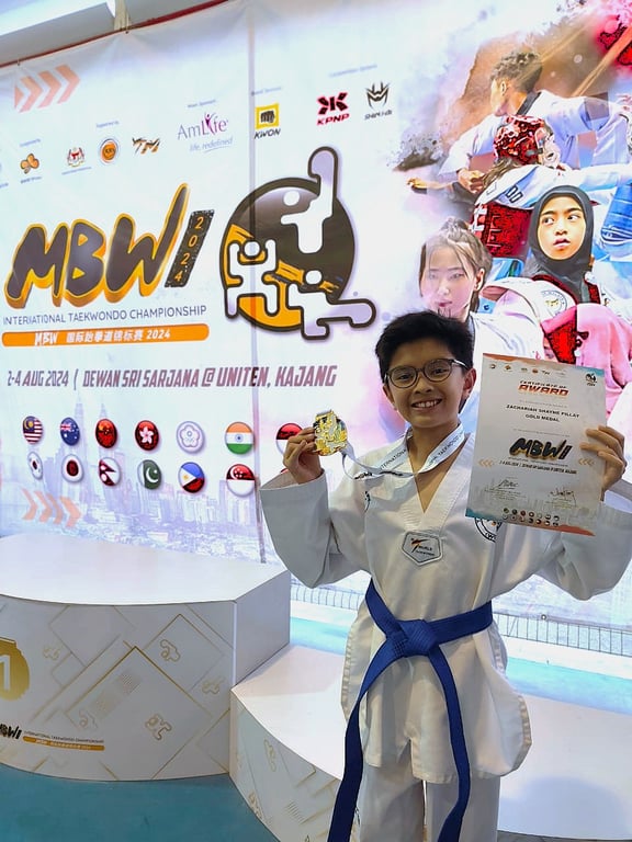 A UUMISM student proudly displays a gold medal and certificate after winning at the MBW International Taekwondo Championship 2024 in Kajang.