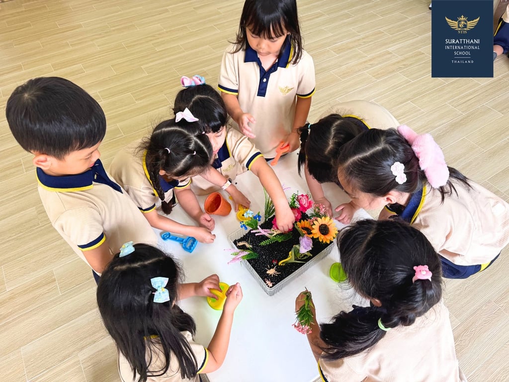 Kindergarten students working together on a flower activity.