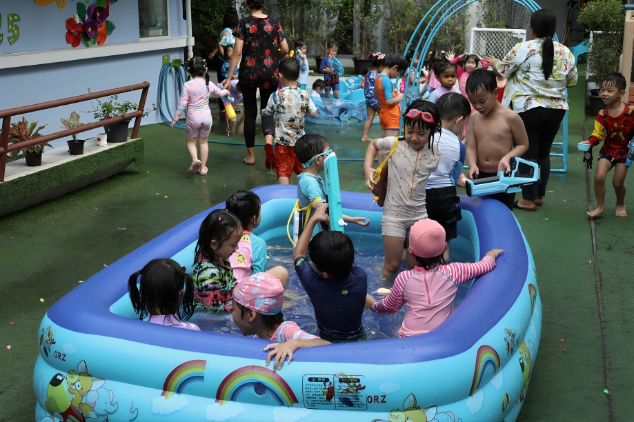 Nursery kids enjoy water play on a sunny afternoon.