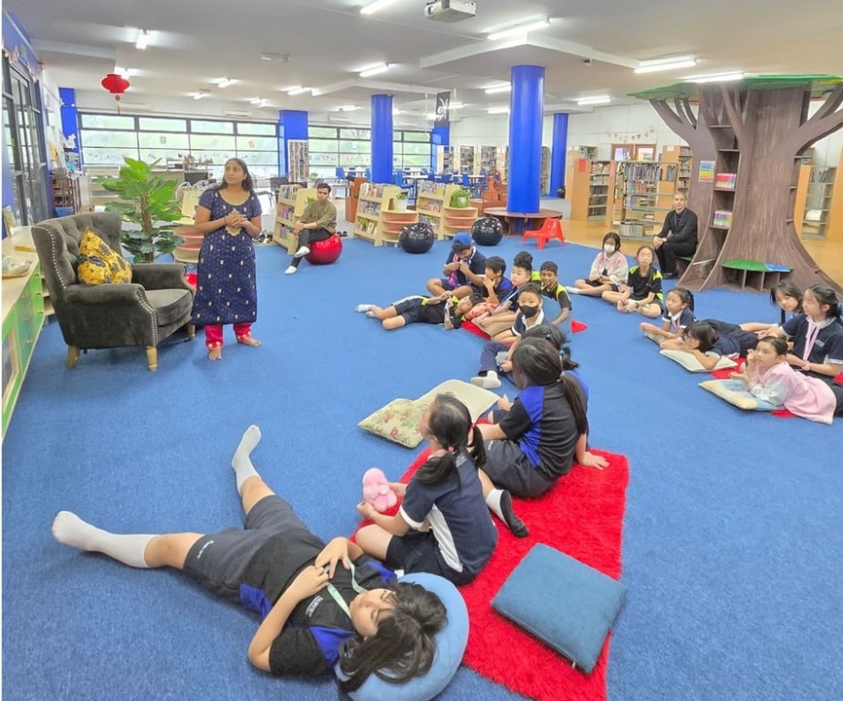 A parent volunteering to read for students during World Read Aloud Day.