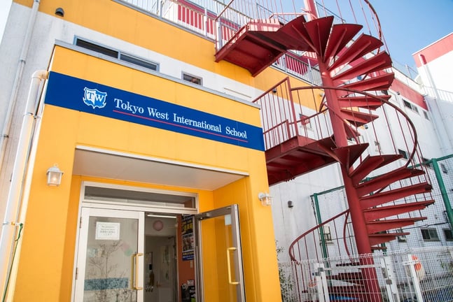Entrance of Tokyo West International School featuring the distinctive red spiral staircase.
