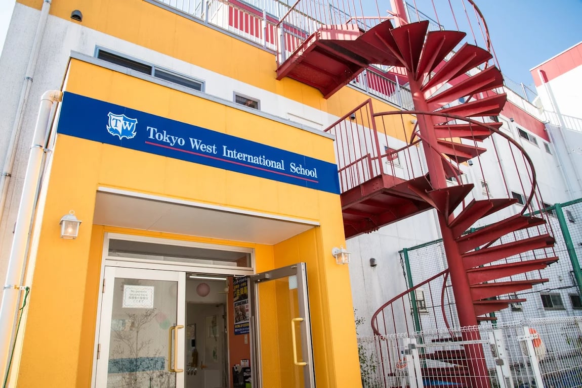 Entrance of Tokyo West International School featuring the distinctive red spiral staircase.