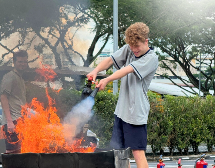 A student taking part in a fire drill organized by the school.