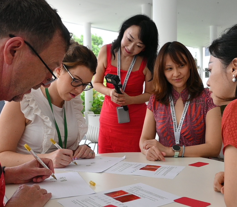 Parents and teachers celebrating Chinese custom together to celebrate 
