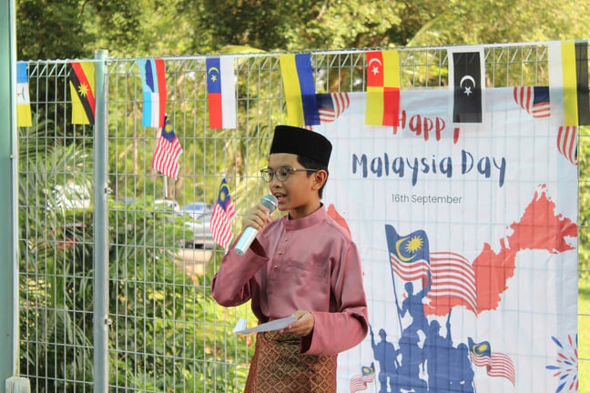 A student delivers a speech during the school’s Malaysia Day celebration.