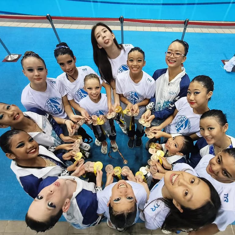 Dover artistic swimmers celebrate with their medals after performing at the 18th Singapore Open Artistic Swimming Championships