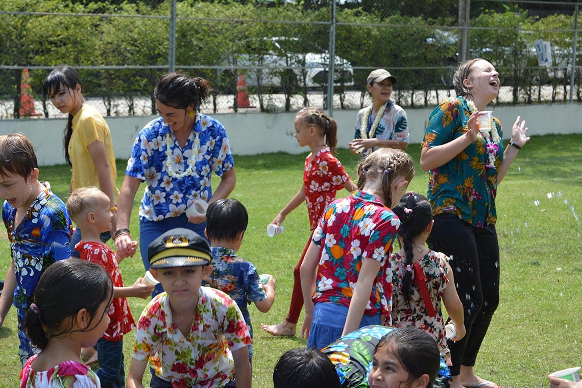 Students and staff taking part in a Songkran water fight.