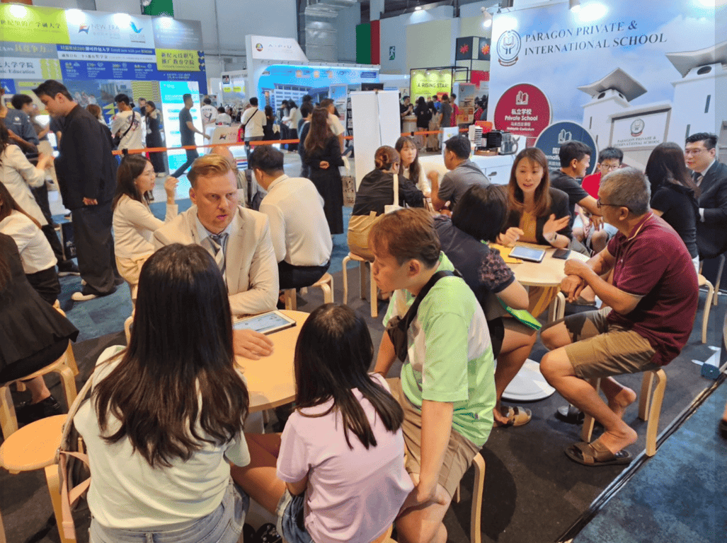 Prospective parents being counselled in an education fair.