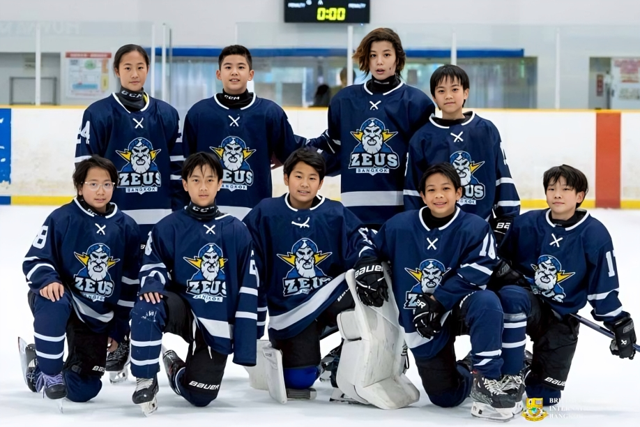 Ice hockey team poses together after the game.