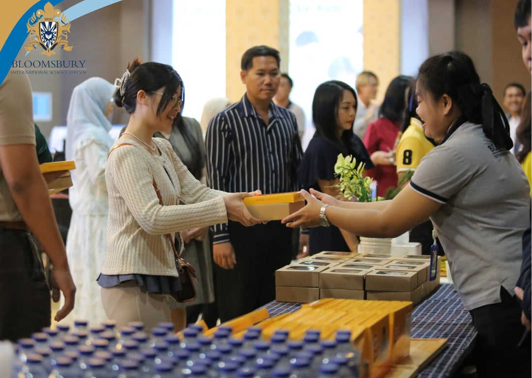 Guests receiving boxed lunches during the school community event.