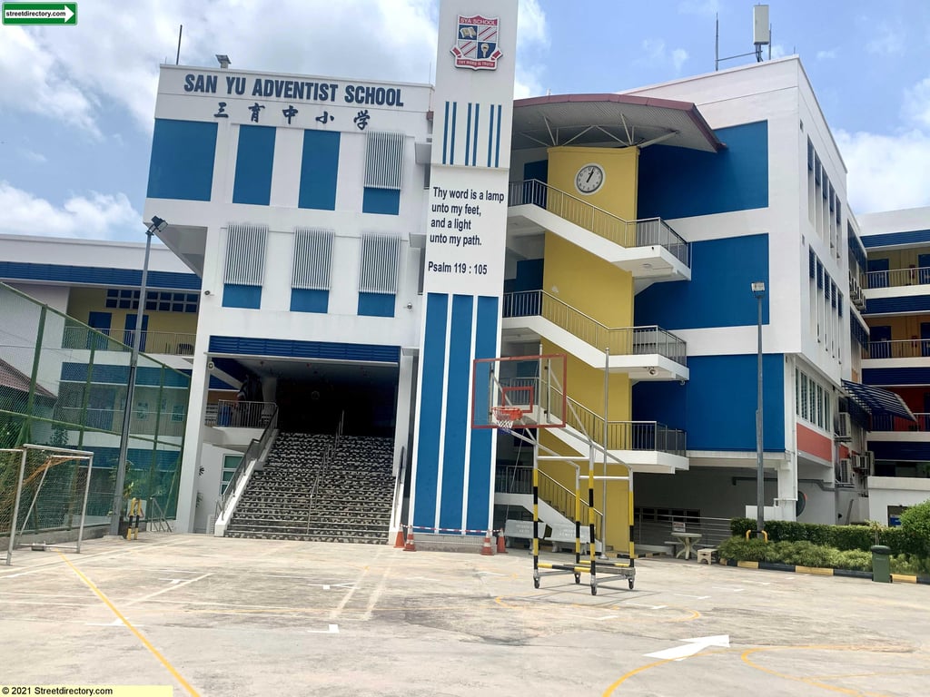 A view from the front of campus, showing the main entrance and buildings