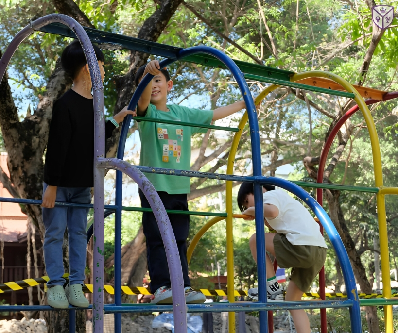 Students enjoy outdoor play on climbing equipment.