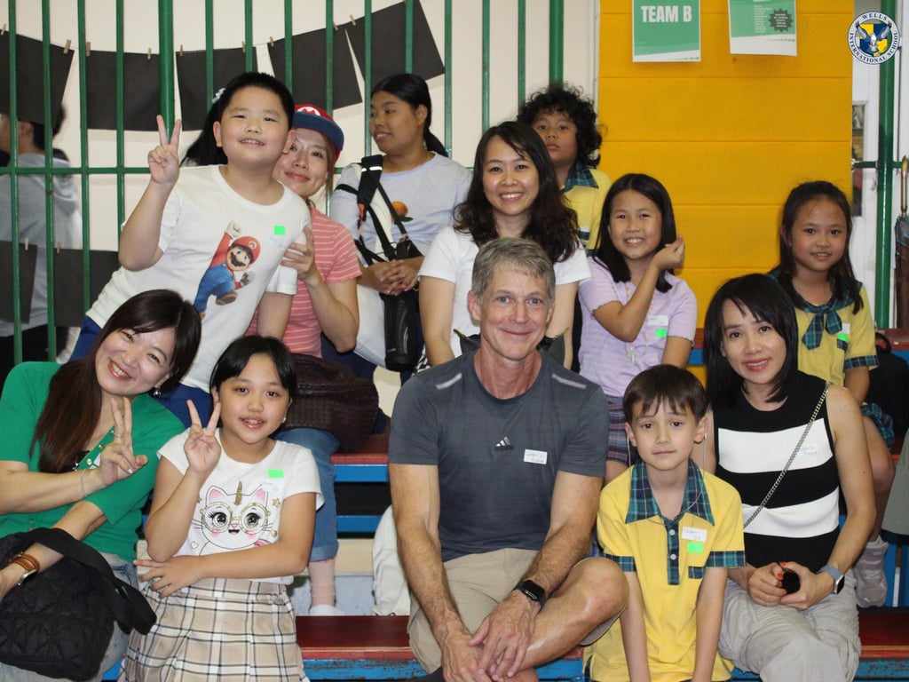 Parents and students posing together at Primary Game Night.