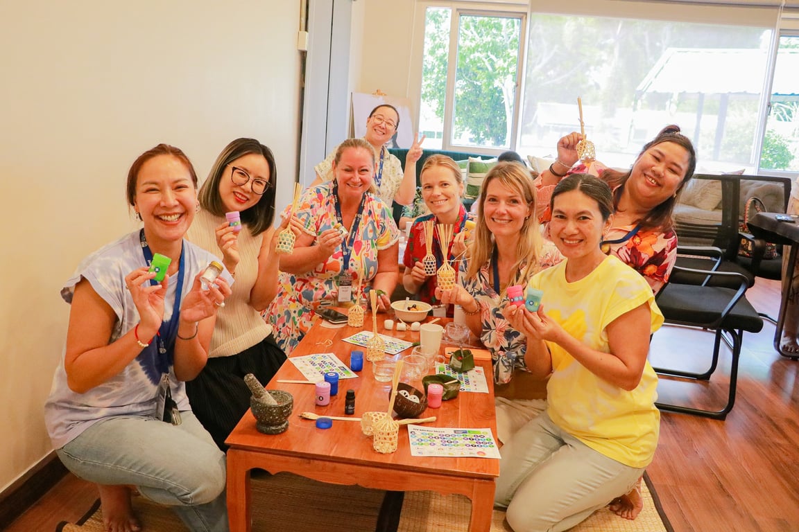 Parents participating in a Ya Dom herbal inhaler workshop during Songkran celebrations.