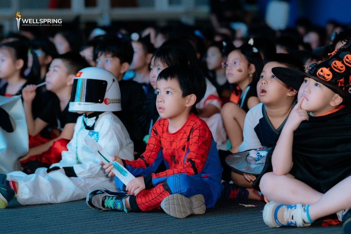 Children in costumes attending a Halloween-themed school event indoors.
