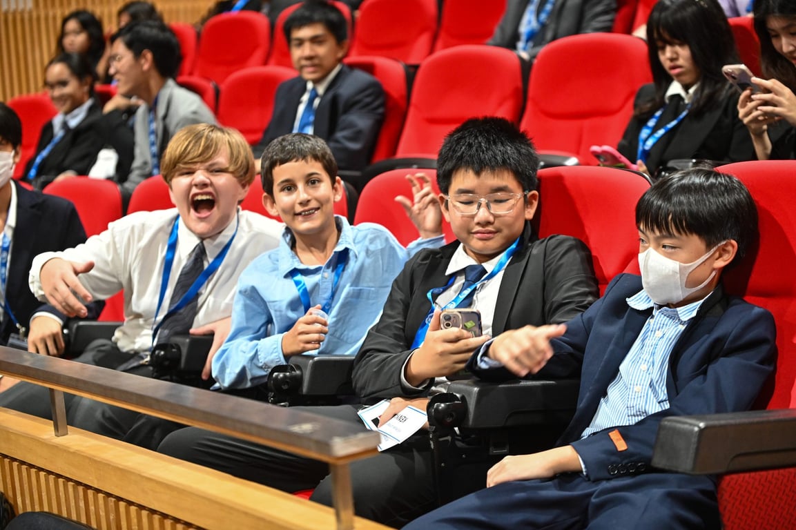 Students seated before the start of a conference session.