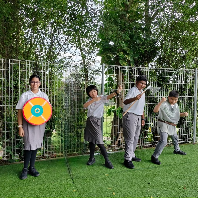 Students pose in creative costumes for a themed history presentation.