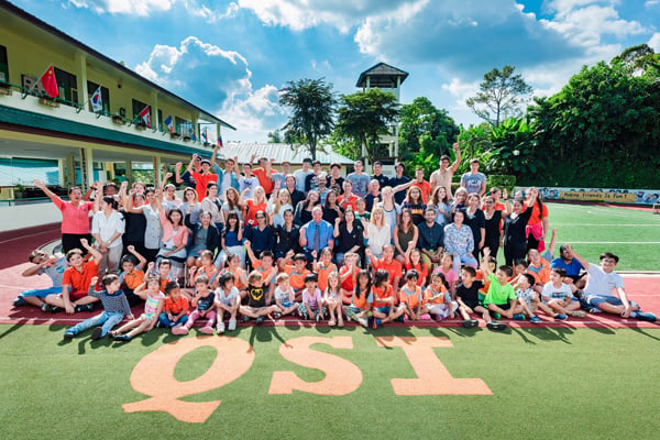 The QSI Phuket community posing for a picture.