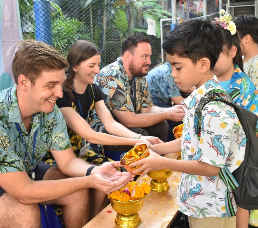Students and teachers celebrating Songkran with a traditional water ceremony.