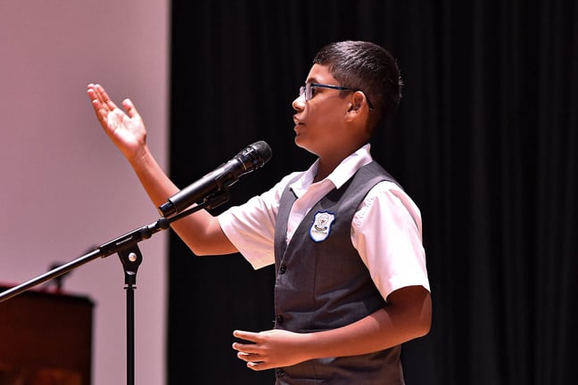 A confident PISM student presenting during the school’s speech competition.