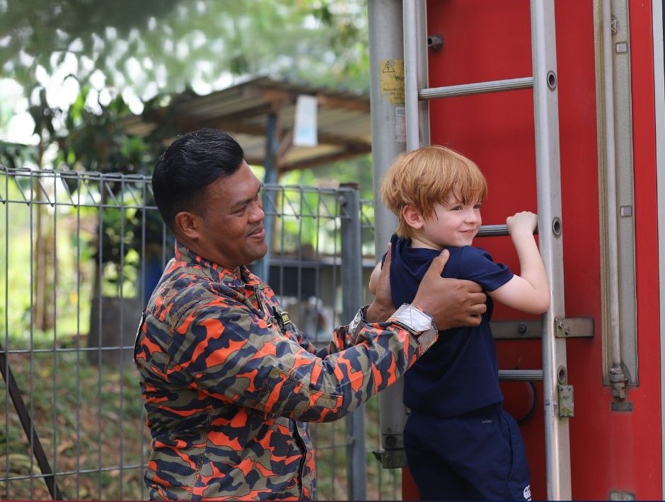 Inspiring courage and care — a firefighter visit teaches pupils safety, service, and community spirit.