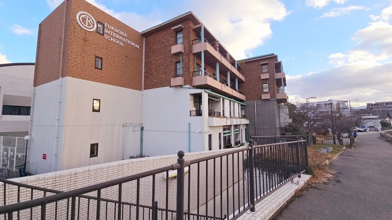 The modern brick and white facade of Fukuoka International School.