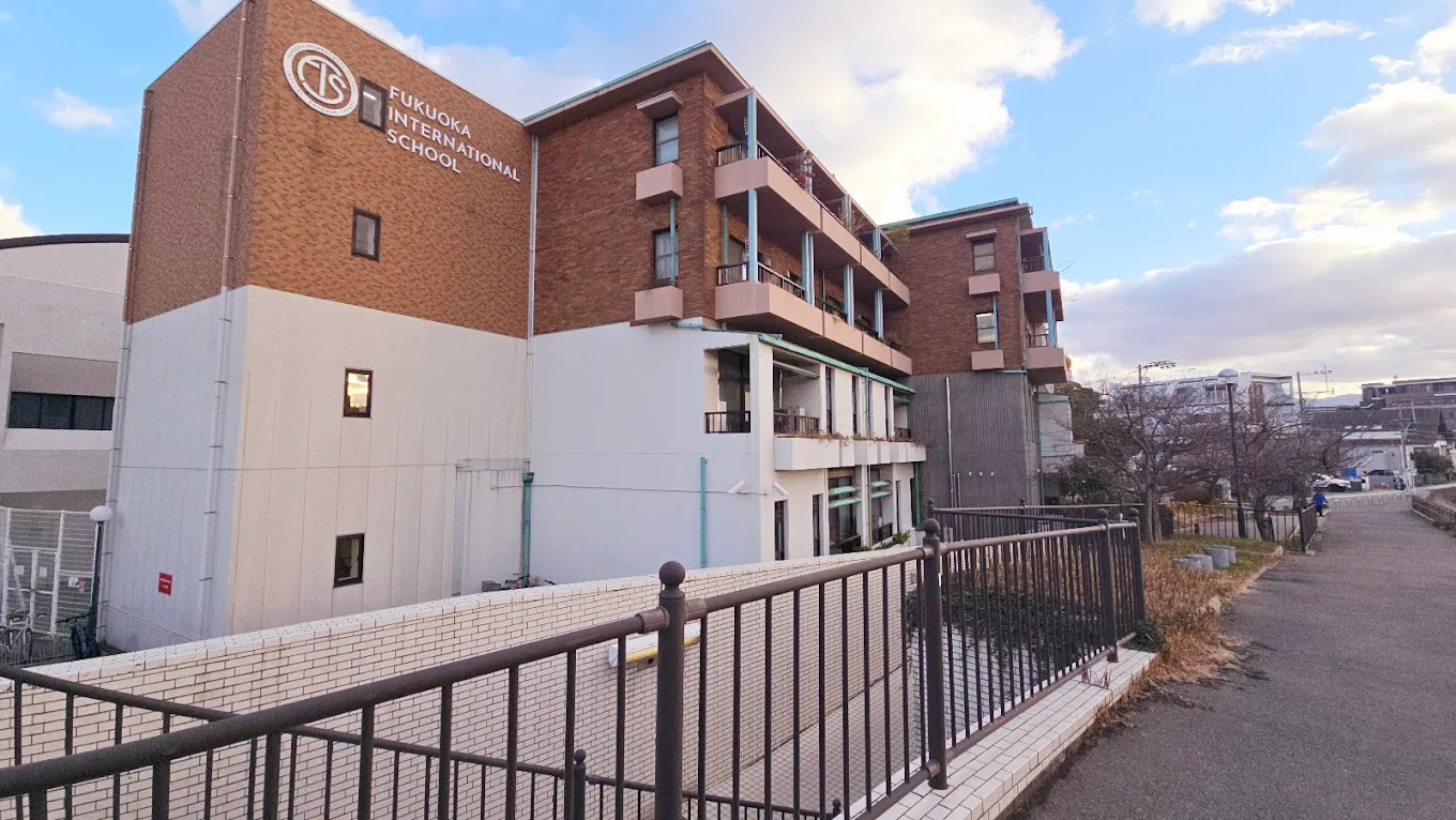 The modern brick and white facade of Fukuoka International School.