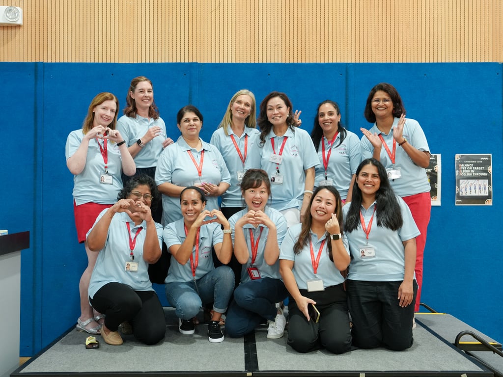 The SAIS PTA pose for a photo at the Welcome Event for new parents