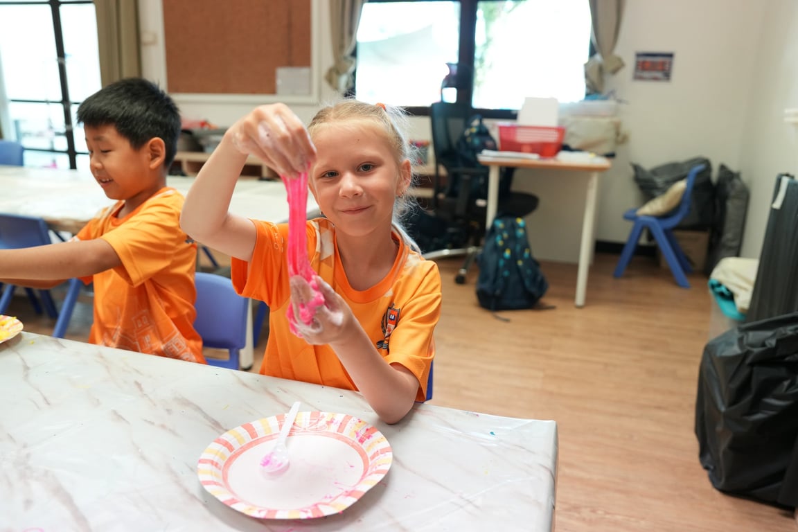 Student making slime during arts and crafts at Summer@BISP.