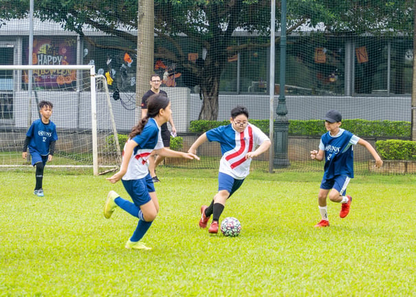 Elementary students playing in an inter-school football festival.