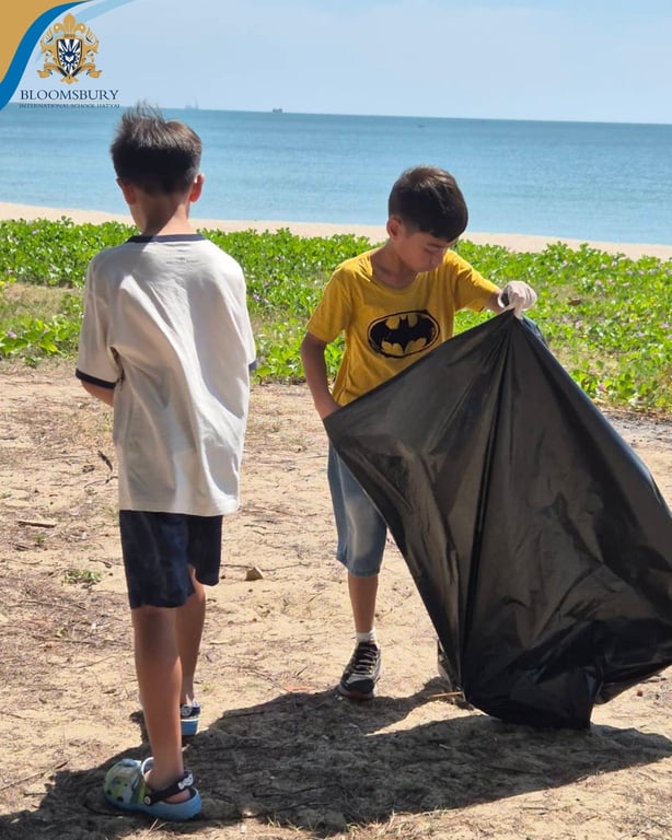 Campers collecting litter during the beach clean-up activity.